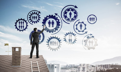 Businessman on house roof presenting teamwork and connection con