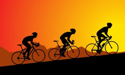 Fototapeta na wymiar Bike racers climbing to the top, at sunset