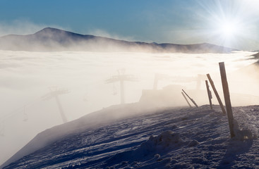 Fototapeta premium Sun over winter mountains, covered with snow.