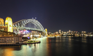 Fototapeta na wymiar Sydney Harbour night time Panorama with bridge in North Sydney