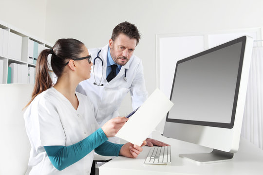 doctors with nurse looking medical records, concept of  consulting