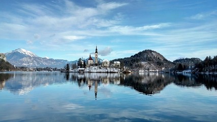 Blue sky and lake with island with a church in the middle of