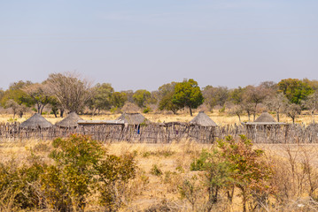 Fototapeta premium Mud straw and wooden hut with thatched roof in the bush. Local village in the rural Caprivi Strip, the most populated region in Namibia, Africa.