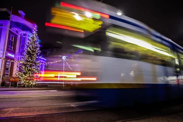  AMSTERDAM, NETHERLANDS - JANUARY 09, 2017: Blurred silhouette of moving tram in Amsterdam city at night. January 09, 2017 in Amsterdam - Netherland. © Unique Vision