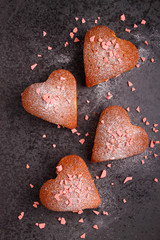 cupcakes in heart with powdered sugar on a black background