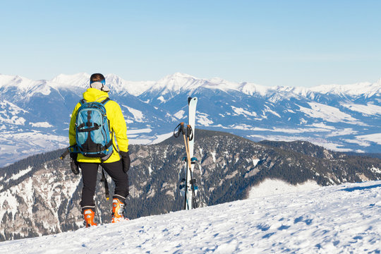 Female skier looking at landscape from the top of a mountain