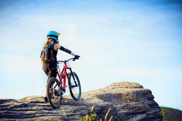 Naklejka na ściany i meble Female MTB mountain biker enjoys the view during cycling trip
