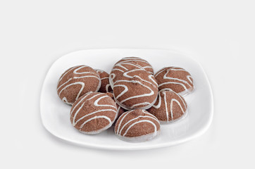 Chocolate chip cookies in a white plate on a white background. Selective focus.