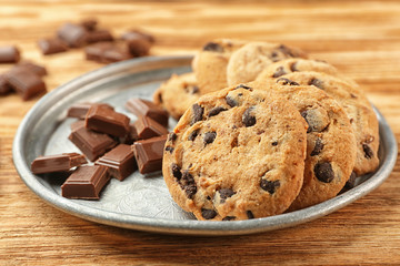Tasty chocolate cookies on tray, wooden background,closeup