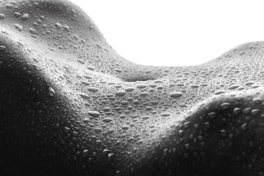 Sexy female body with drops of water close up
