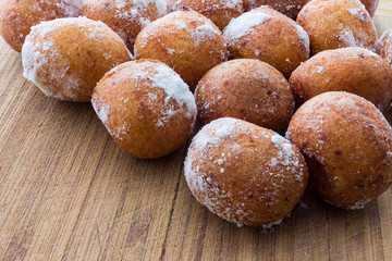 Round doughnuts dusted with powdered sugar