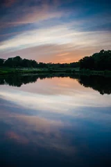 Foto op Canvas beautiful sunset over the lake, a warm summer evening © alipko