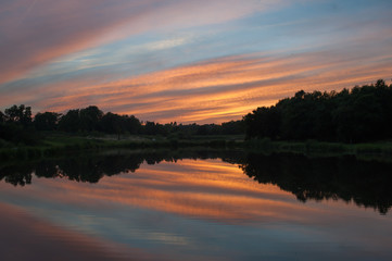 Naklejka na ściany i meble beautiful sunset over the lake, a warm summer evening