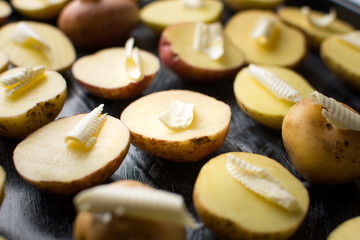 Potato with butter on a baking plate