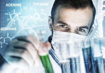 Portrait of concentrated male scientist working with reagents in laboratory