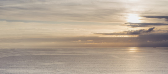 Clouds sky and sunlight sunset on horizon ocean. People on background seascape dramatic atmosphere rays sunrise. Relax view waves water sea, mockup nature evening concept perspective ocean sunrise