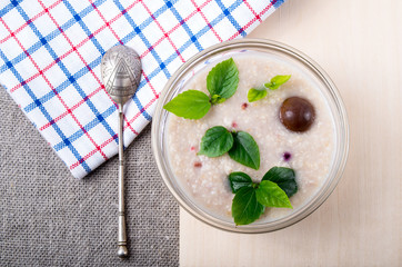 Oatmeal with chocolate candy and a silver spoon