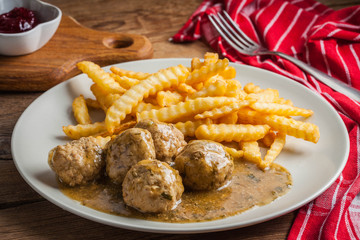 Meatballs with french fries in dill sauce.