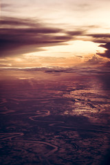 Fototapeta premium Dramatic sunset over the earth from the height in vintage style with epic sky
