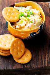cheese bacon dip with crackers.