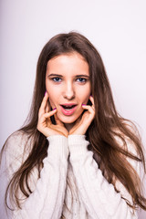 Portrait of young  exited fashion girl in white sweater on white