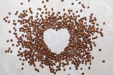 heart of coffee beans on a black background