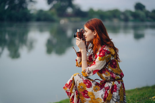 a woman with a camera takes pictures of nature