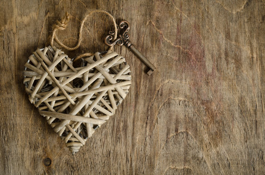 wicker heart handmade with the key on a wooden base
