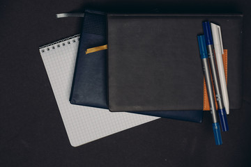 pen and notebook on a gray background
