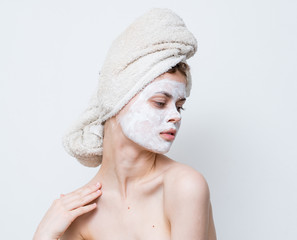 nude woman with a towel on her head, skin care, face