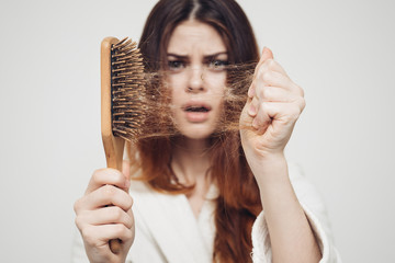 girl with a comb in his hand on a white background distressed hair