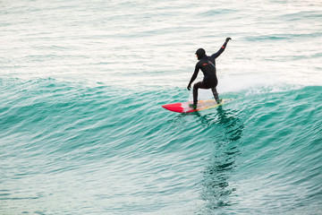 Surfing on turquoise wave in ocean