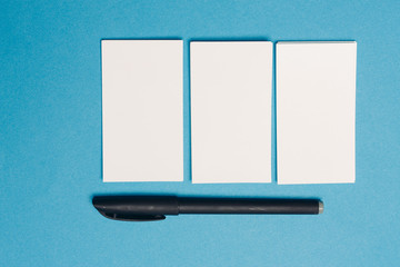 card on a blue background and a pen business card