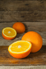 Oranges Fruits and Orange Slice on Wooden Table and Retro Fabric