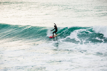 Surfer on wave in ocean. Winter