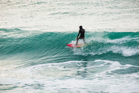Surfer on wave in ocean.
