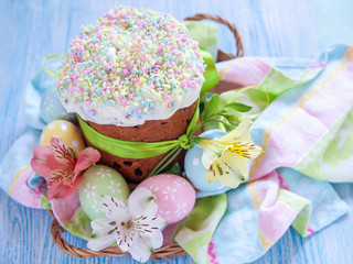 Easter cake and colorful eggs on table