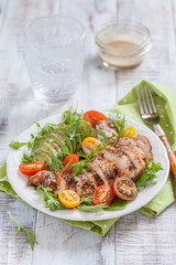 Healthy salad plate with colorful tomatoes, chicken breast and avocado