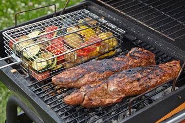 pork tenderloin and vegetables on the grill