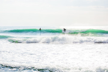 Clear wave and surfer in ocean. Sunny day