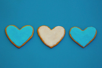 Homemade heart shape cookies on blue background