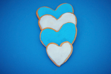 Homemade heart shape cookies on blue background