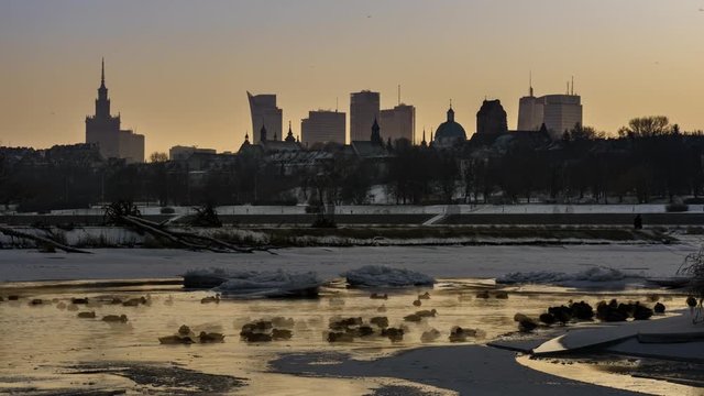 Night view of Warsaw downtown over Vistula river in winter time timelapse