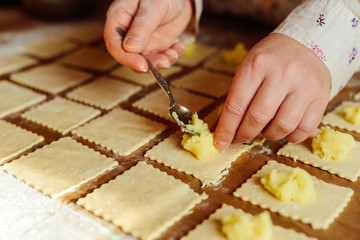 Making of pierogi with potato Vareniki. Russian food . Rustic