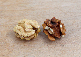 two organic walnuts on a wood background