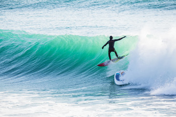 Surfing and blue wave in ocean. Sunny day