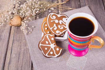 Coffee with homemade gingerbread on the grey wooden table