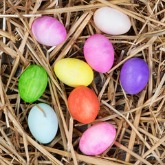 Colorful eggs for Easter holiday on natural straw 