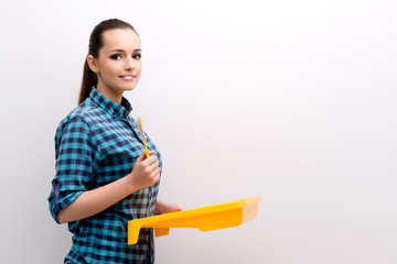 Woman painting house in DIY concept