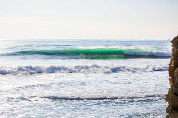 Naklejka na ściany i meble Green wave in ocean. Sunny day